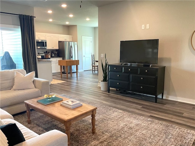 living room with dark hardwood / wood-style flooring