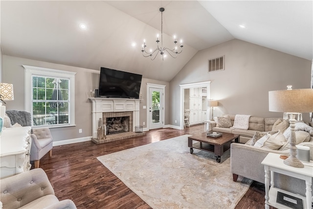 living room with a notable chandelier, high vaulted ceiling, dark wood-type flooring, and a brick fireplace