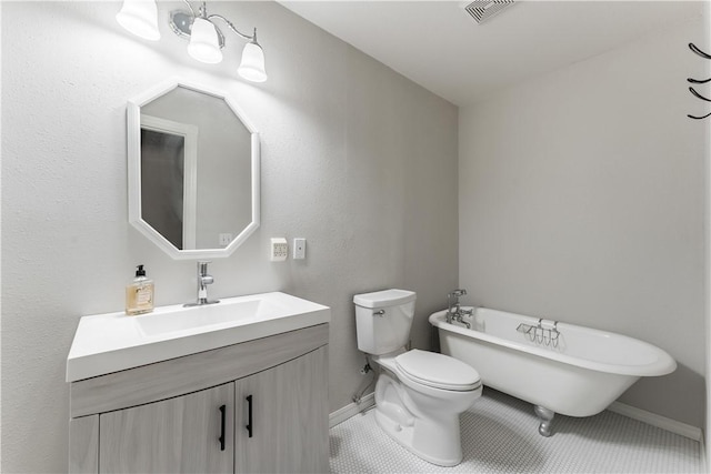 bathroom featuring vanity, visible vents, a freestanding bath, tile patterned floors, and toilet