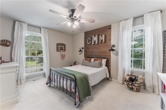 carpeted bedroom featuring visible vents and ceiling fan