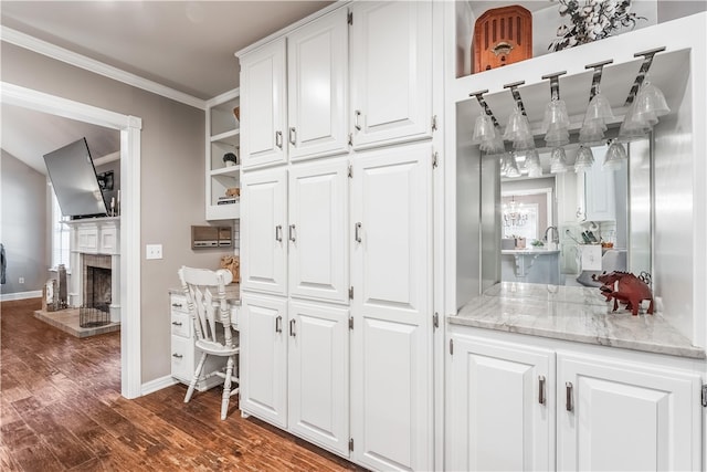 kitchen featuring white cabinets, crown molding, and open shelves