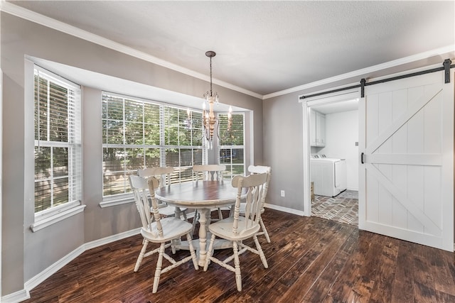 dining space featuring a barn door, plenty of natural light, dark wood-style floors, and washing machine and clothes dryer