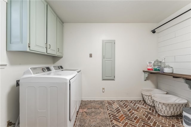 laundry area with brick floor, baseboards, cabinet space, and independent washer and dryer