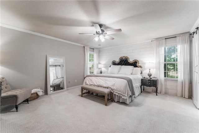 carpeted bedroom with a textured ceiling, a ceiling fan, baseboards, and ornamental molding