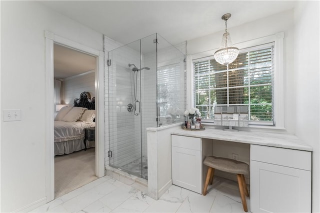 bathroom with marble finish floor, an inviting chandelier, a shower stall, and connected bathroom