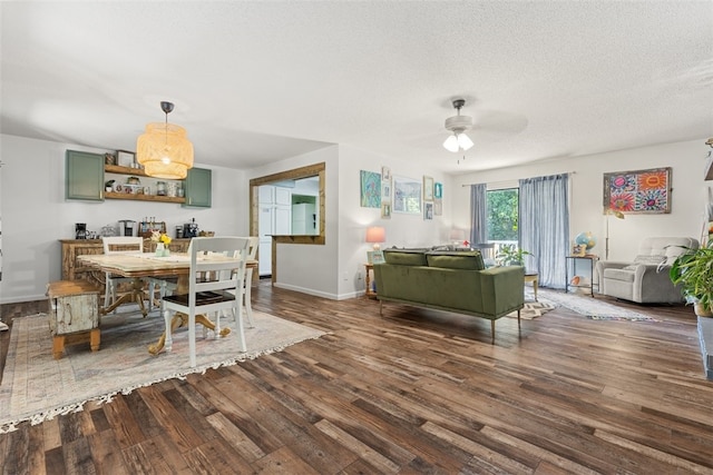 dining space with a textured ceiling, ceiling fan, and hardwood / wood-style floors