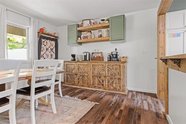 dining room featuring a textured ceiling and dark hardwood / wood-style floors