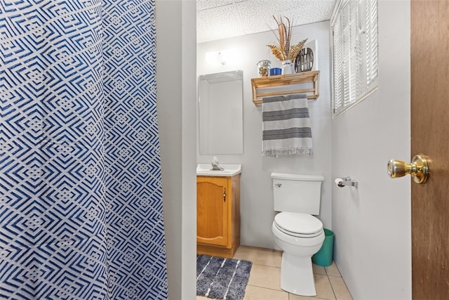 bathroom featuring tile patterned flooring, toilet, and vanity