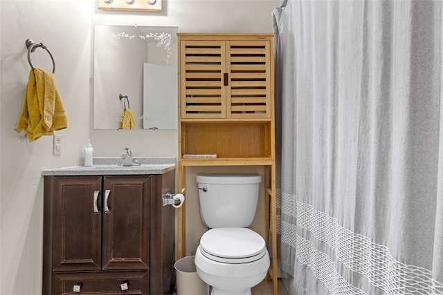 bathroom with toilet, vanity, and a shower with curtain