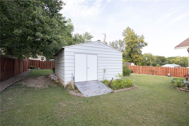 view of outbuilding featuring a lawn