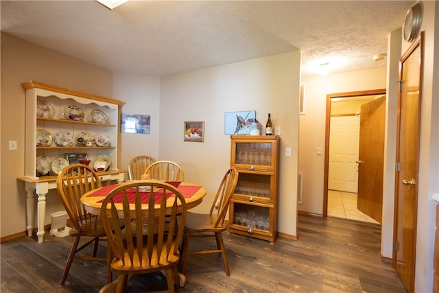 dining area with hardwood / wood-style flooring and a textured ceiling