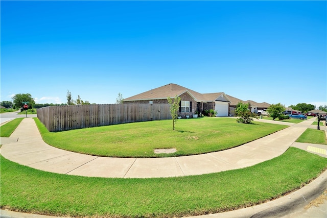 single story home with a garage and a front yard