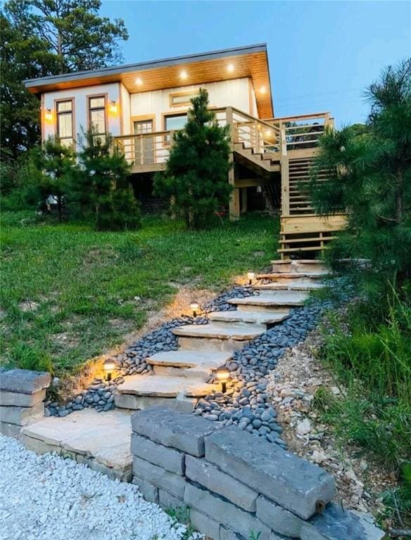 back of house featuring a deck and stairway