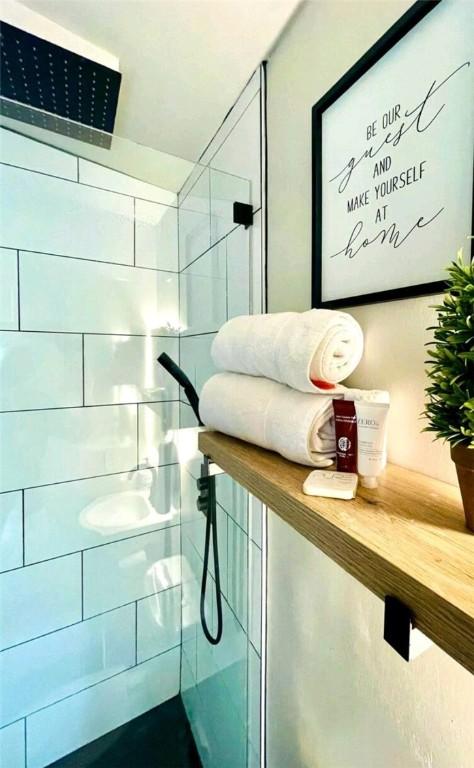 bathroom with a tile shower