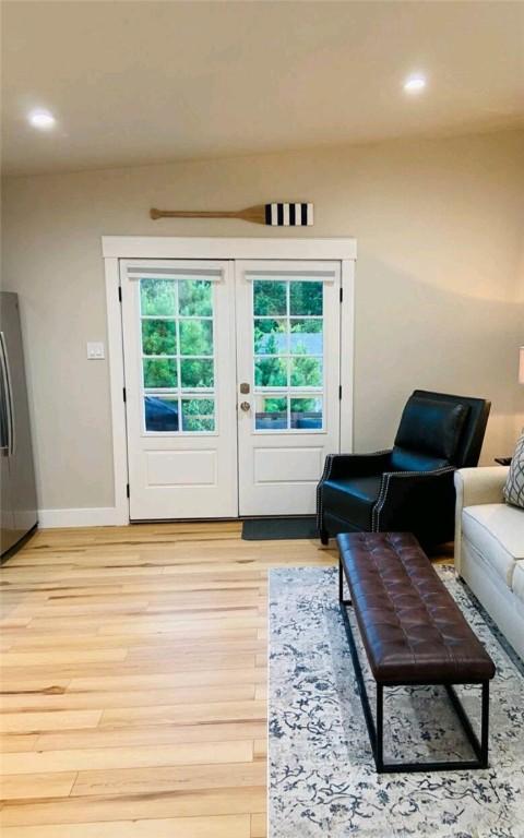 doorway to outside featuring light wood-style floors, recessed lighting, french doors, and baseboards