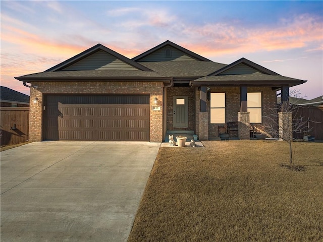 view of front of property featuring a yard and a garage