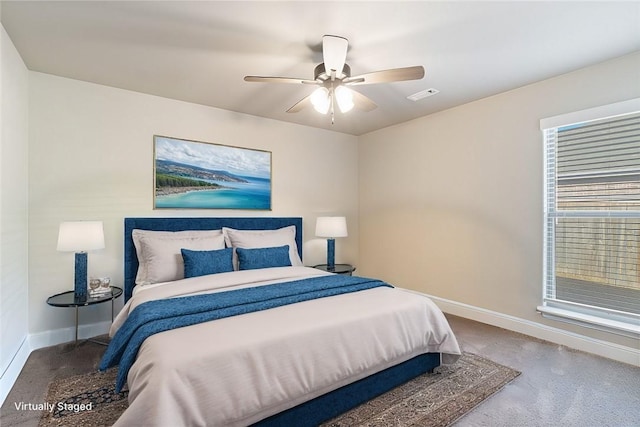 carpeted bedroom with ceiling fan and multiple windows