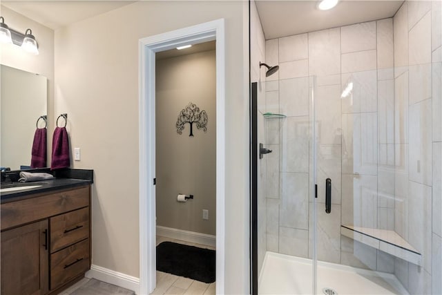 bathroom featuring vanity and a shower with door