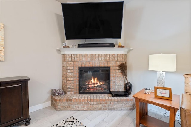 living room featuring a brick fireplace