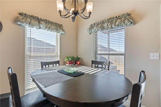 dining space with plenty of natural light and an inviting chandelier