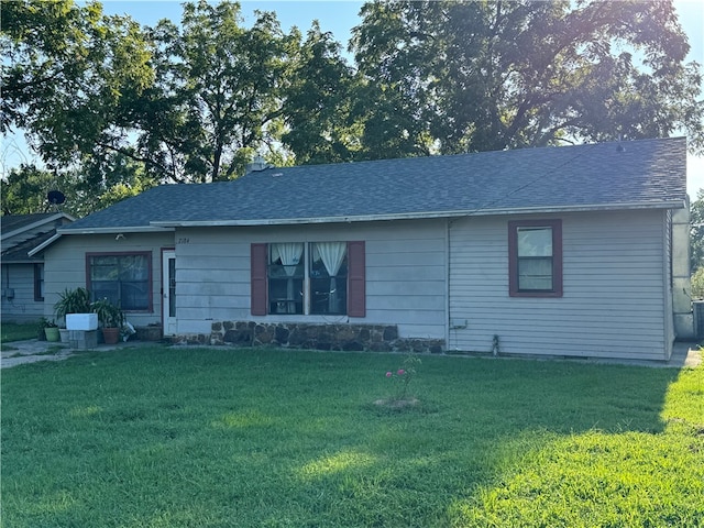 ranch-style home with a front lawn