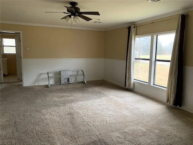 unfurnished room with ceiling fan, ornamental molding, and carpet flooring