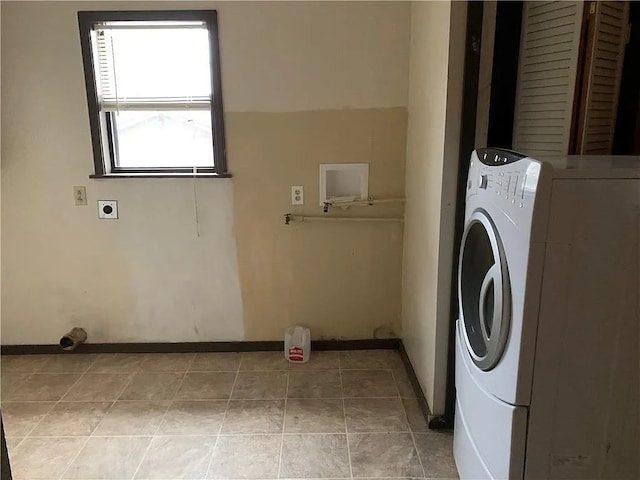 washroom with tile patterned flooring and washer / dryer