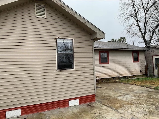 view of side of home featuring a patio area