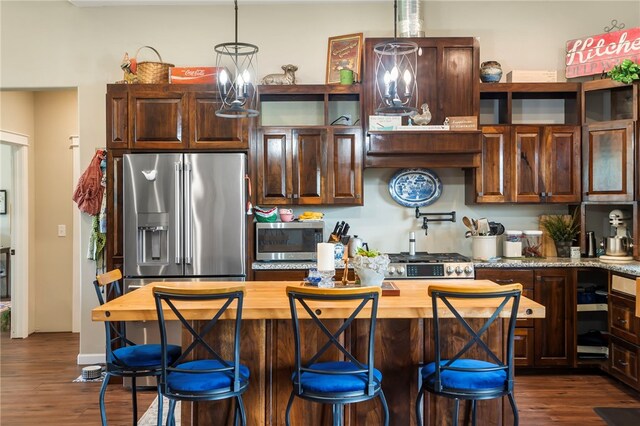 kitchen with a breakfast bar, hanging light fixtures, dark hardwood / wood-style flooring, custom exhaust hood, and stainless steel appliances