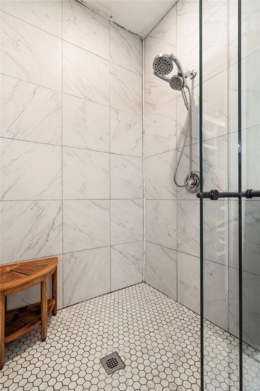 bathroom with a tile shower