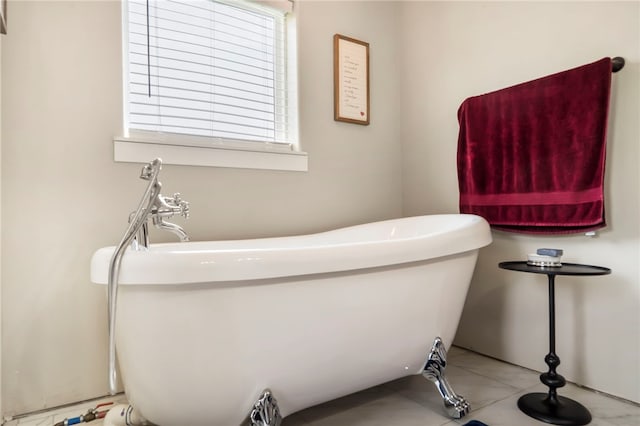 bathroom featuring tile patterned floors and a bathtub