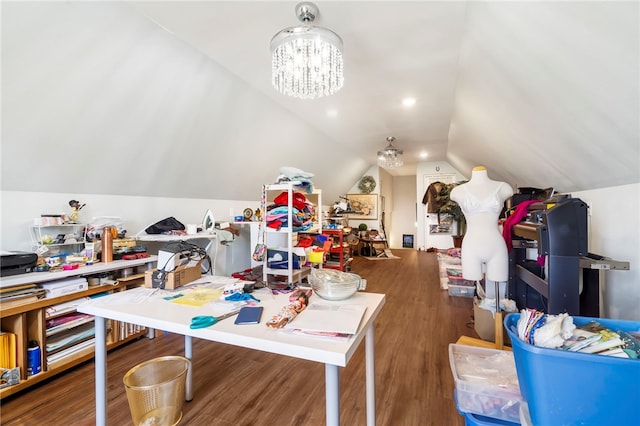 game room featuring hardwood / wood-style flooring, vaulted ceiling, and an inviting chandelier