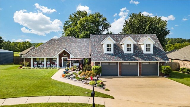 view of front of home with a garage and a front lawn