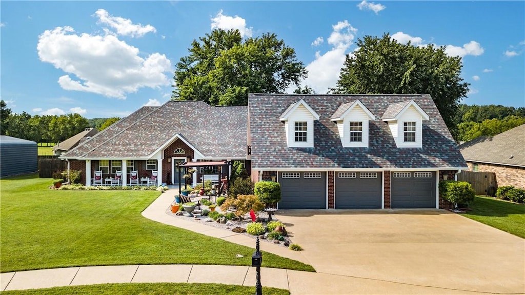 view of front of property with driveway, brick siding, an attached garage, and a front yard