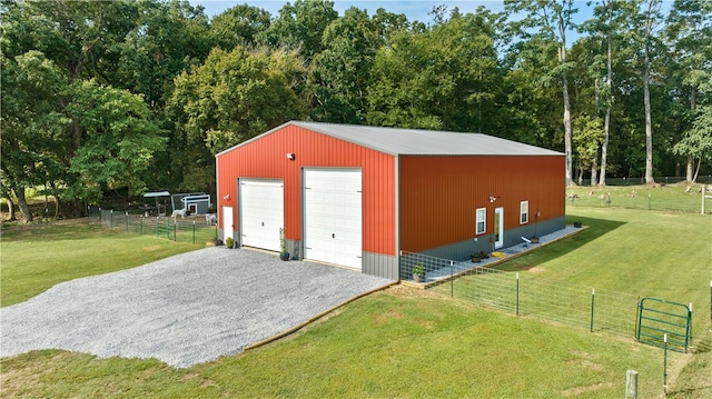 view of outbuilding featuring a rural view, a yard, and a garage