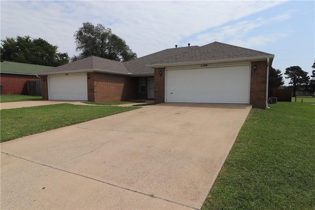 ranch-style home with a garage, brick siding, concrete driveway, and a front yard