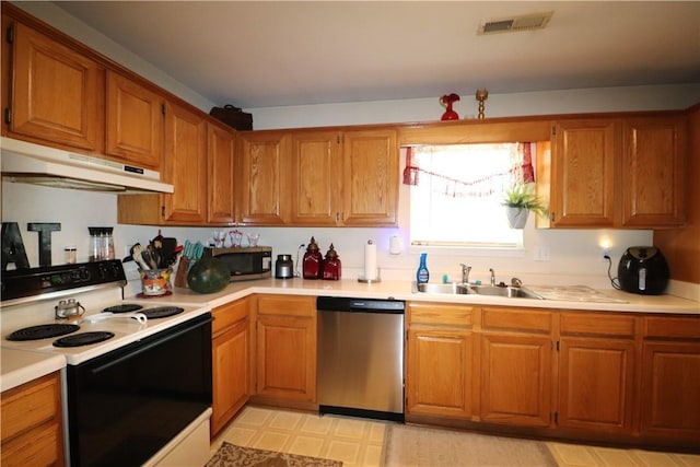 kitchen featuring light countertops, appliances with stainless steel finishes, a sink, and under cabinet range hood