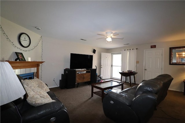 living area featuring carpet floors, a fireplace, a ceiling fan, and baseboards