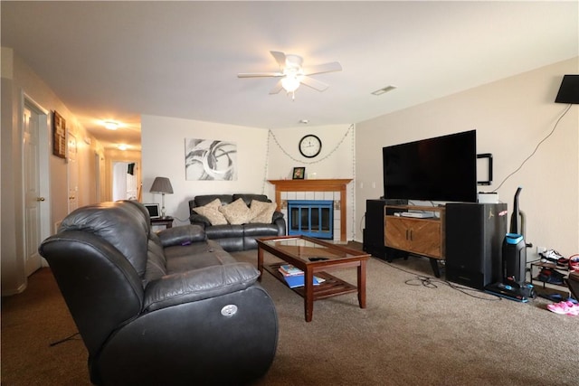 living area featuring carpet floors, a fireplace, visible vents, and a ceiling fan