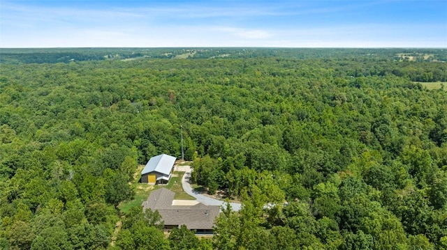 bird's eye view with a wooded view