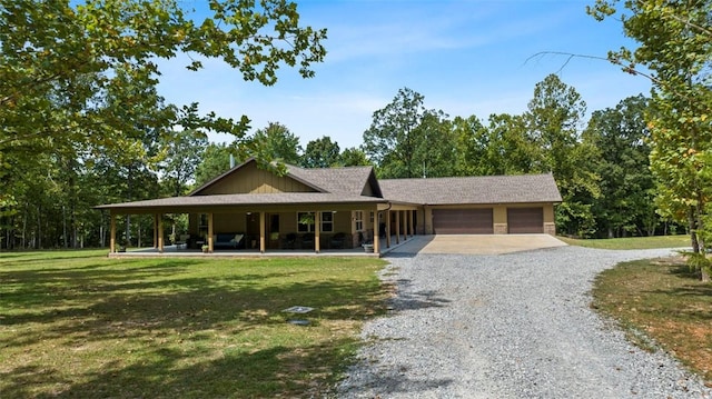 view of front of home featuring driveway, a front lawn, and an attached garage