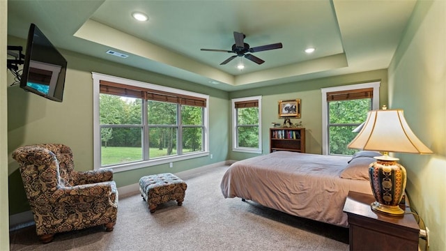 carpeted bedroom with recessed lighting, a raised ceiling, a ceiling fan, and baseboards