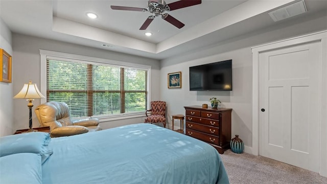 bedroom featuring carpet, visible vents, a tray ceiling, and recessed lighting