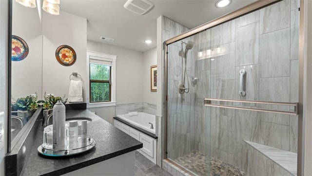 bathroom with a garden tub, recessed lighting, visible vents, a shower stall, and vanity