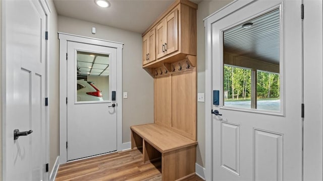 mudroom with light wood-style floors and baseboards