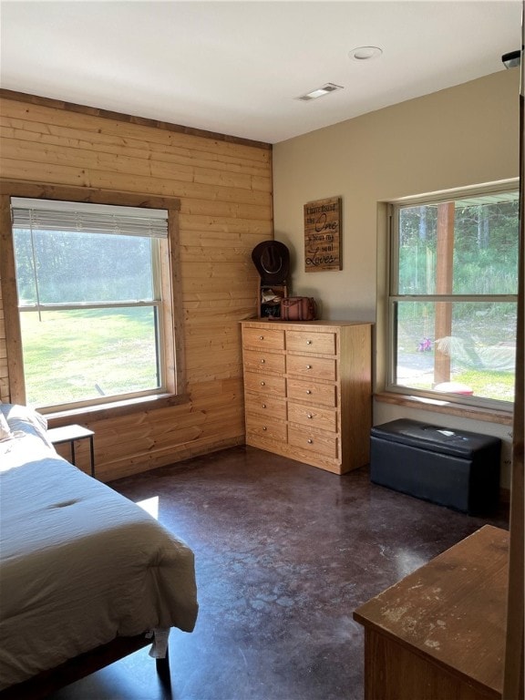 bedroom with wood walls