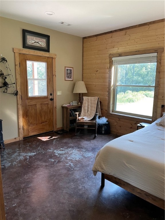 bedroom featuring wood walls