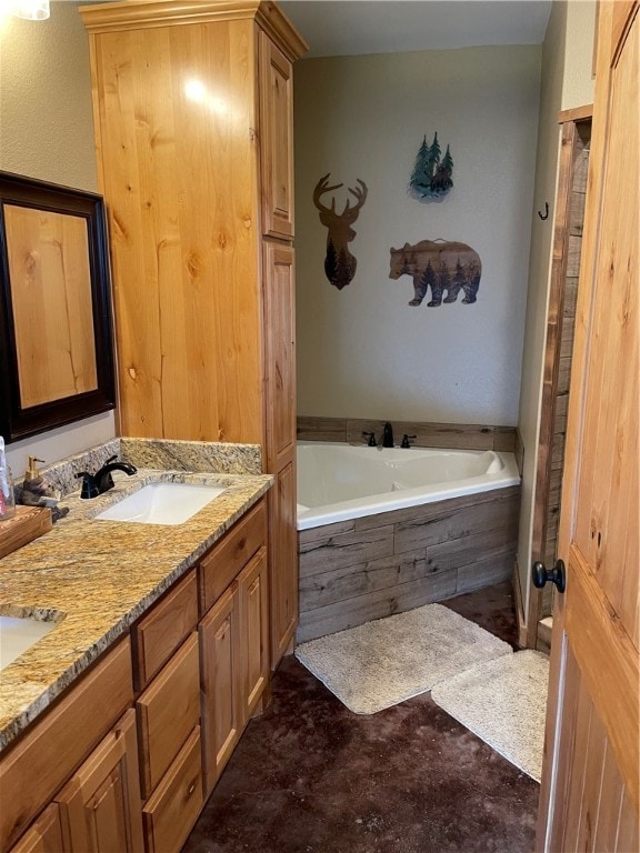 bathroom with tiled tub and vanity