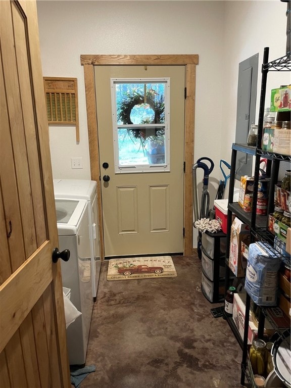 clothes washing area with independent washer and dryer and electric panel