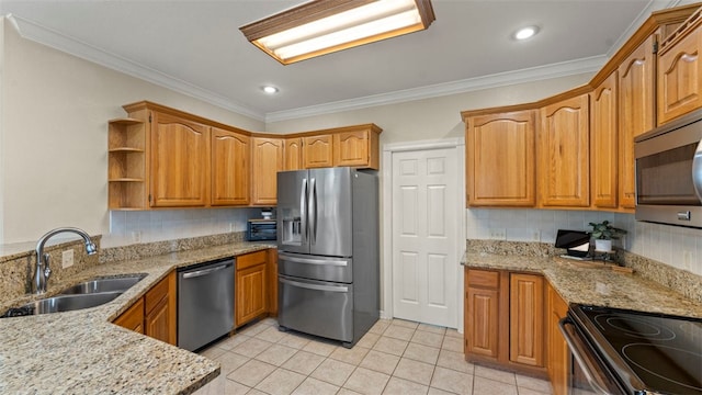 kitchen with light stone counters, appliances with stainless steel finishes, and light tile patterned flooring